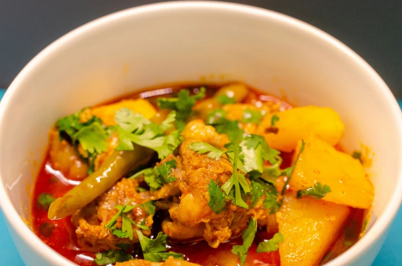 a bowl filled with soup and vegetables on a table