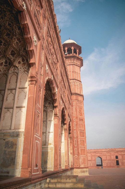 the tall brick building has an elaborate decorative clock tower