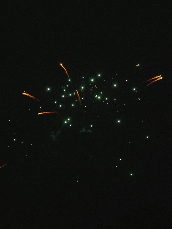 a group of fireworks that are glowing on the sky