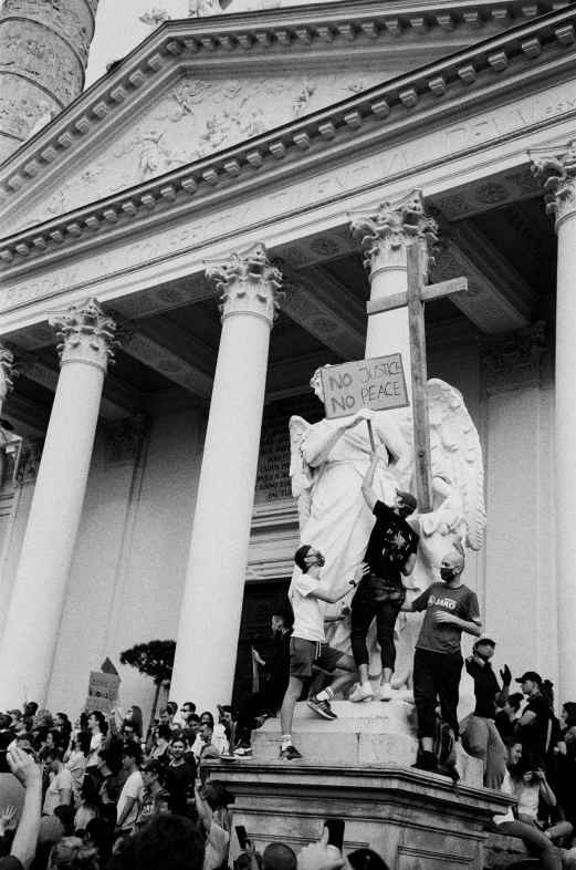 this is the black and white image of people gathered around a statue