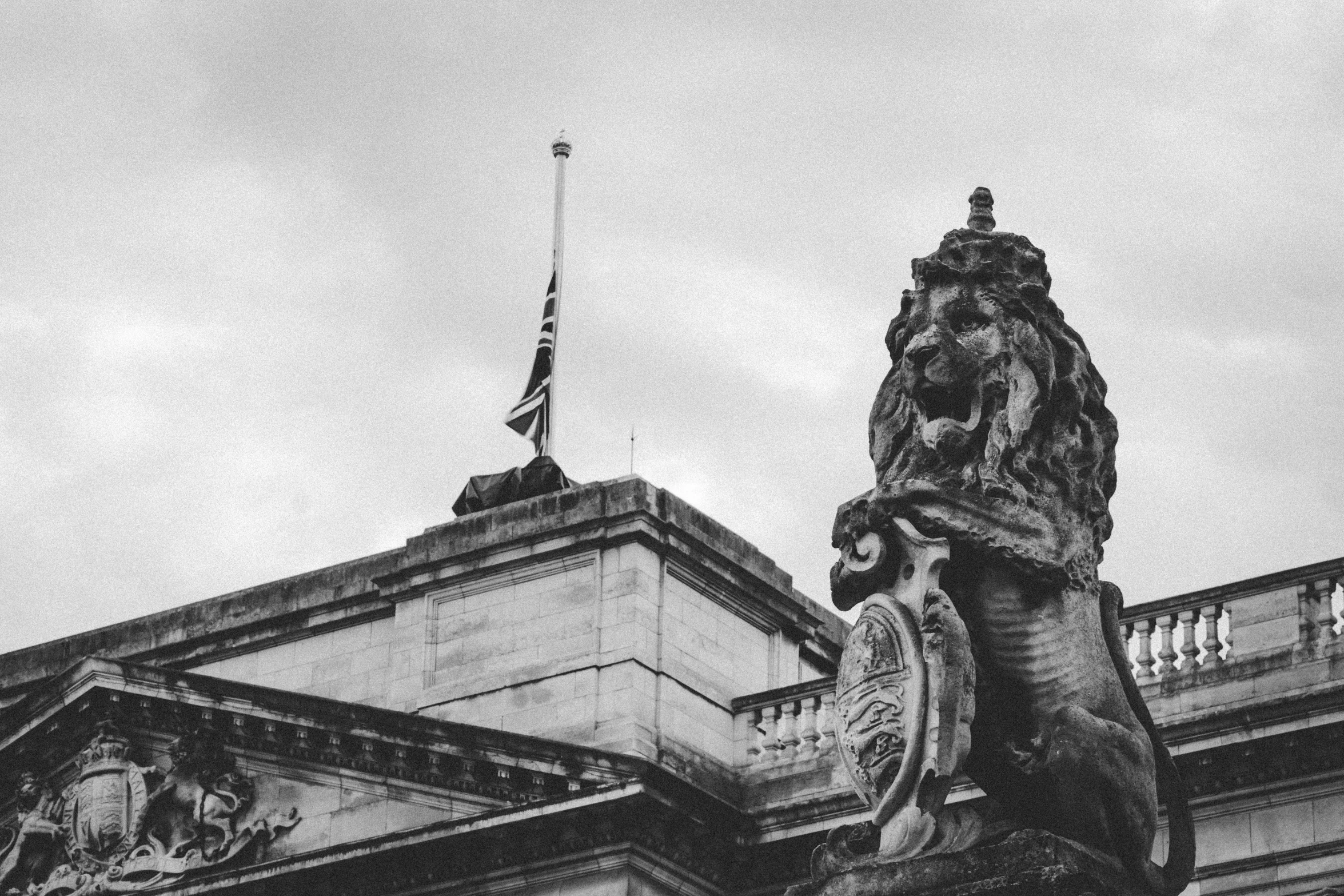 a building with a very tall tower and a statue