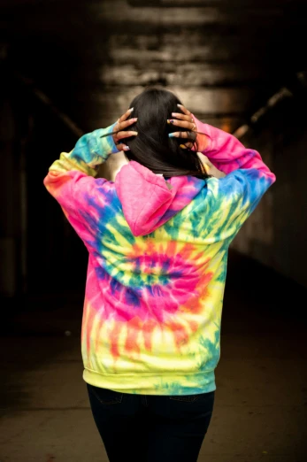 the back view of a person in a colorful tie - dyed hoodie