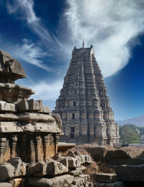 the tower structure on top of a temple with a sky background