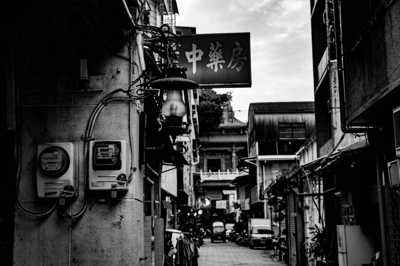 a street with several chinese lanterns on a wall