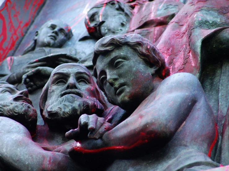 a close up view of a statue with faces painted on it