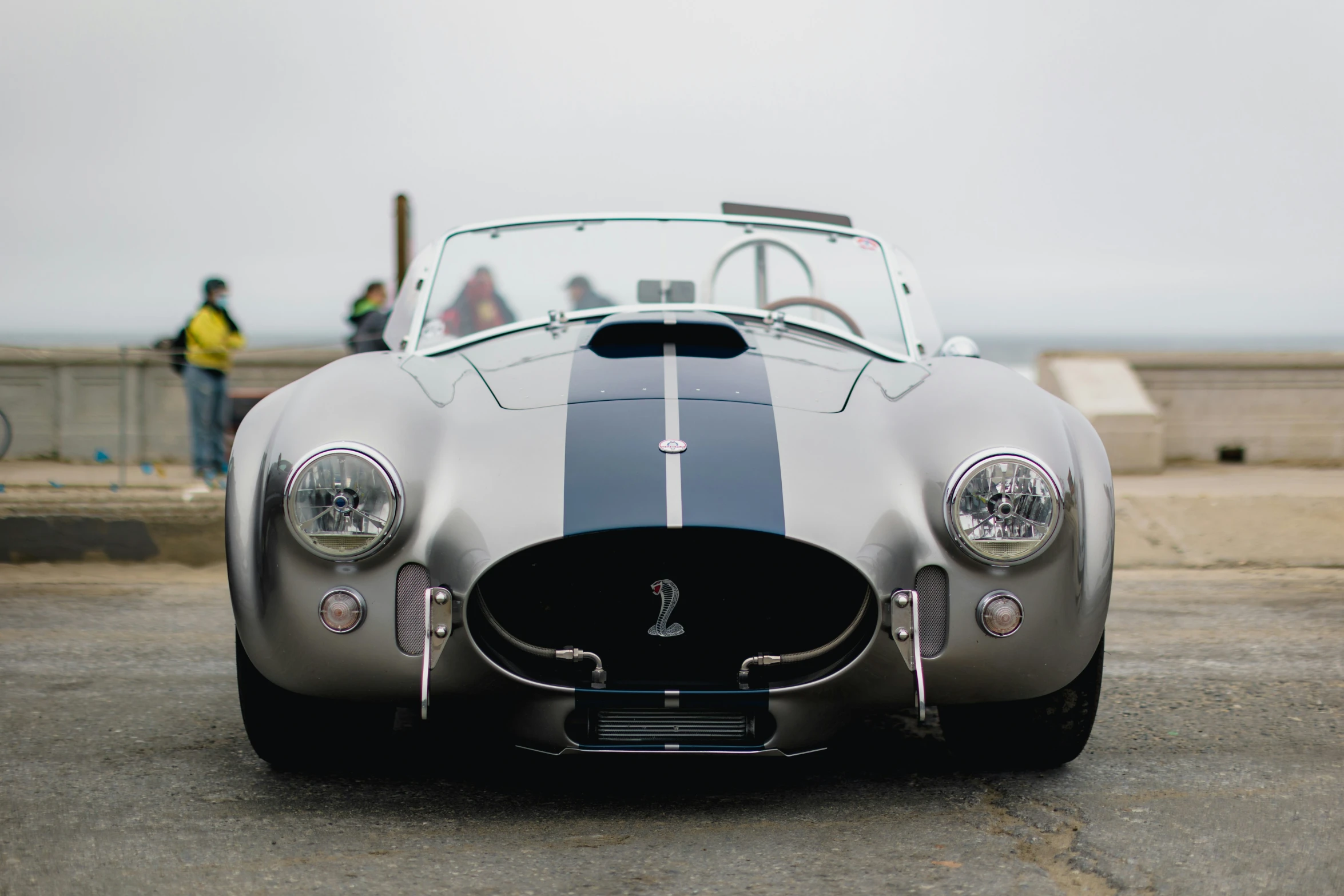 the sports car with silver stripe is parked