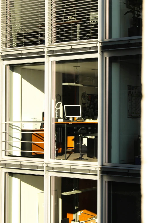 an office in an apartment building reflected in the windows