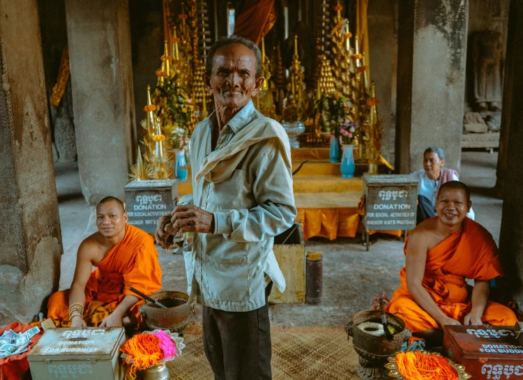 several people are at a temple sitting and walking