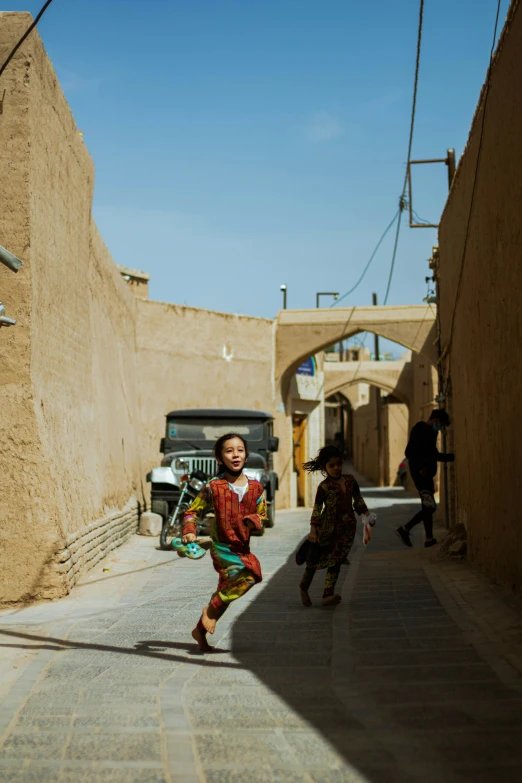 children playing around in the street in a rural area