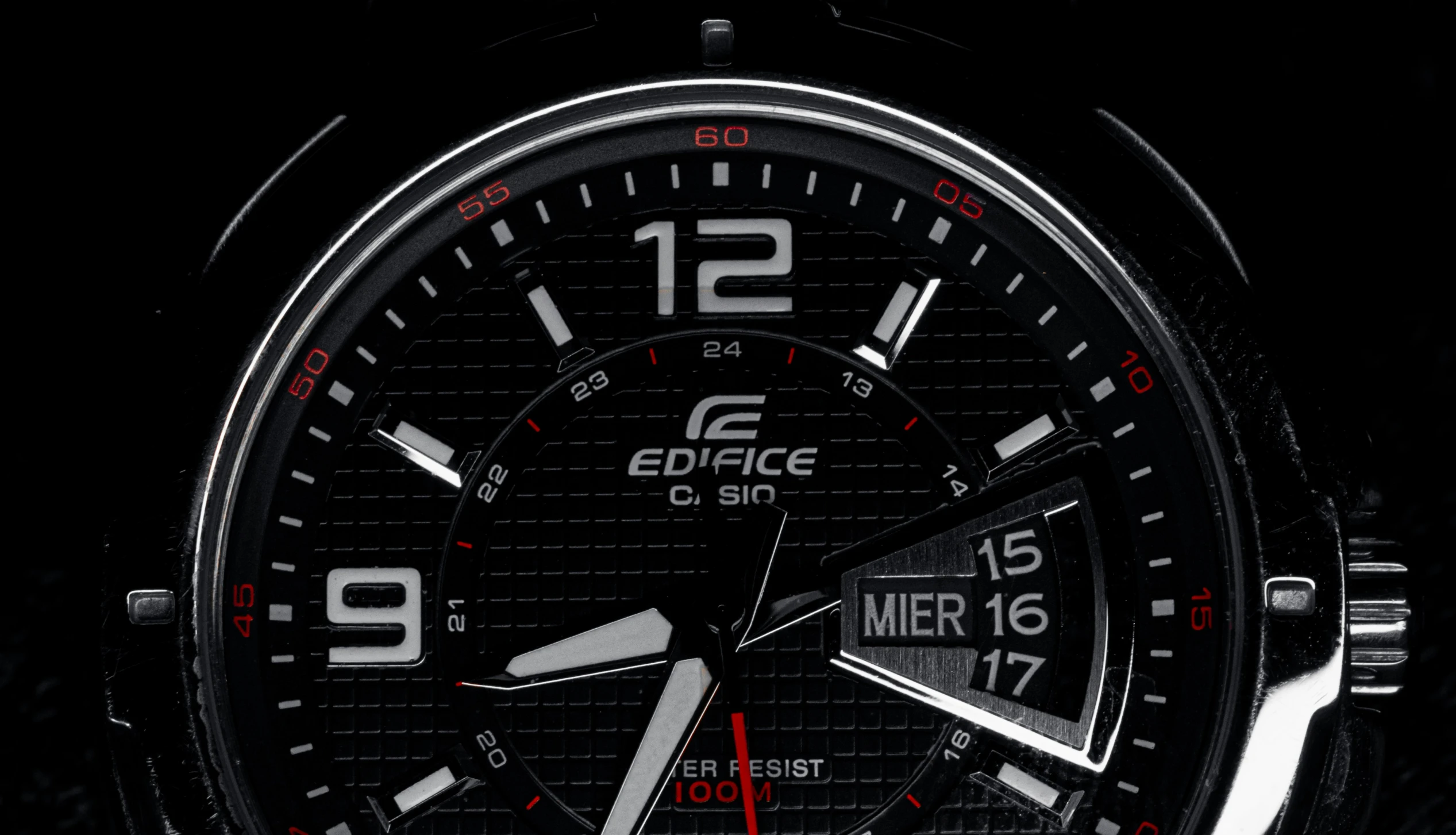 closeup of a wrist watch with a black background