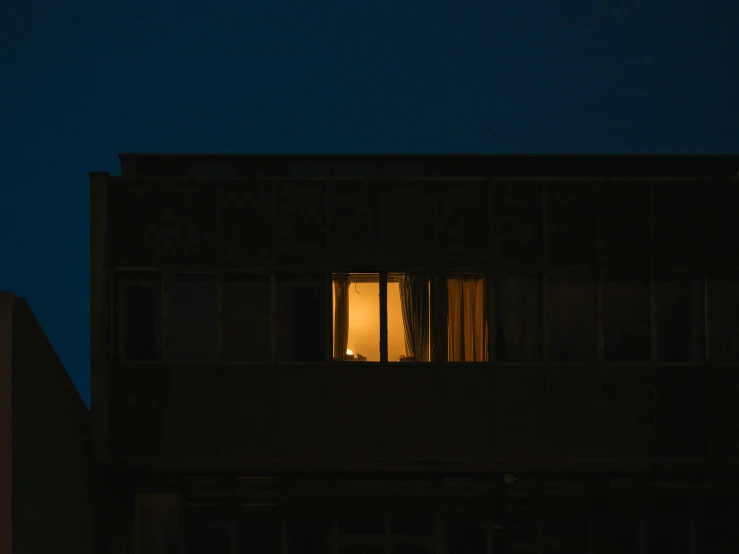 a building and an apartment block at night