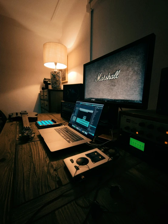 an open laptop and monitor are on a desk