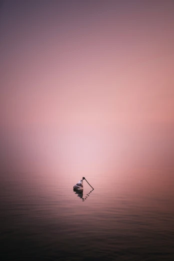 a lone boat in the middle of an empty ocean