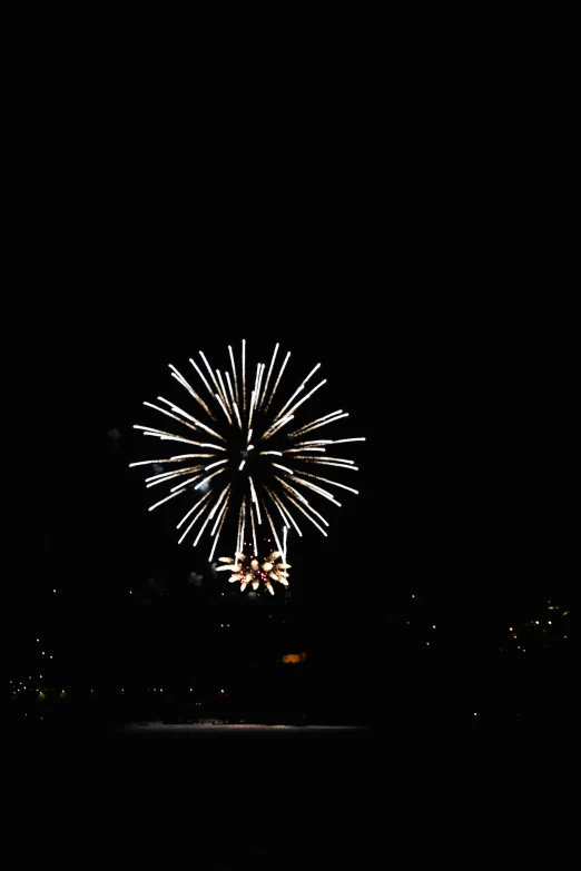 a fireworks is seen in the sky at night