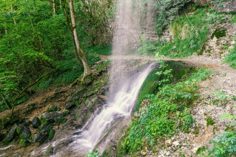 a small waterfall falling into the air