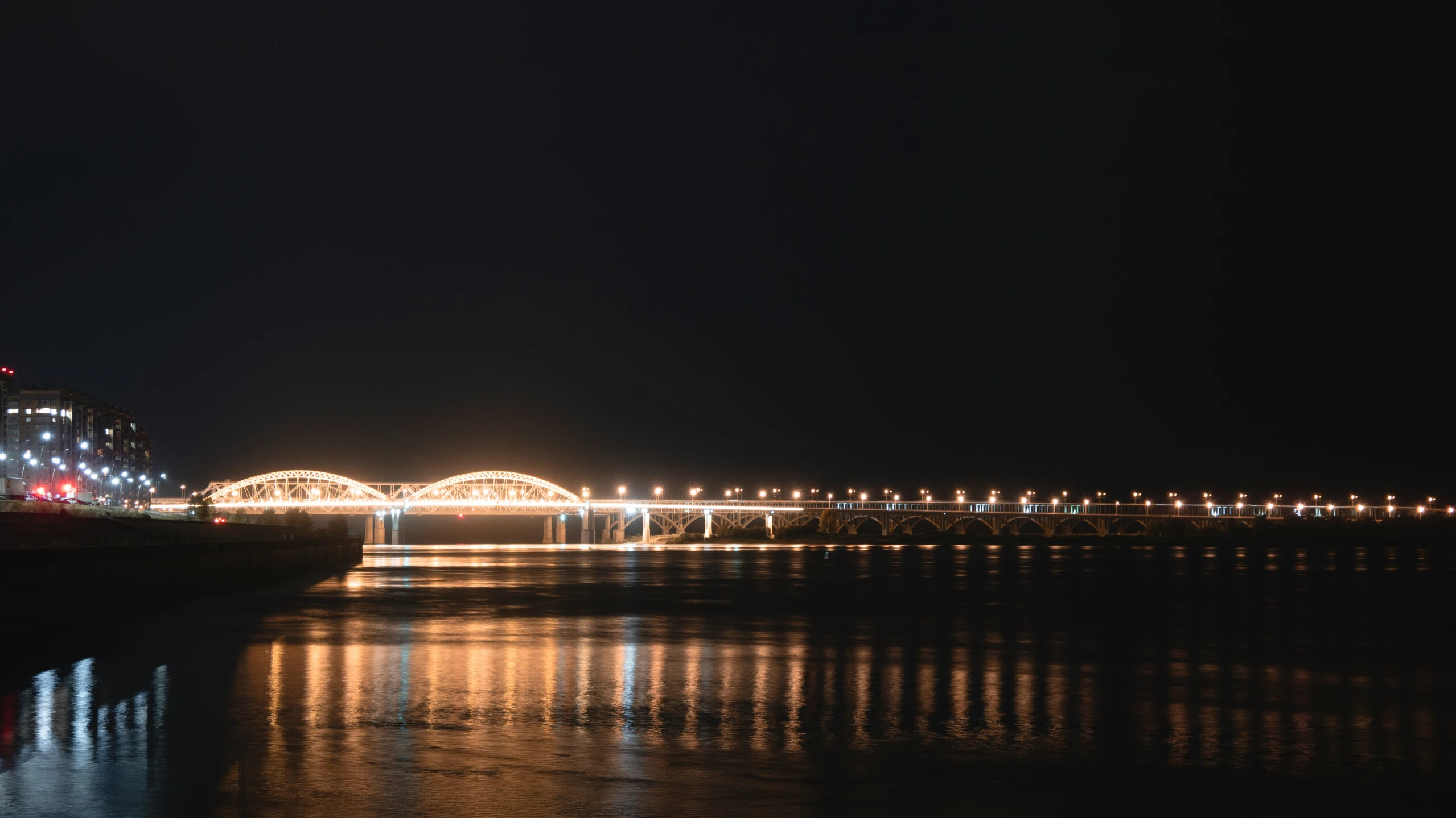 a light bridge and other lights near a body of water