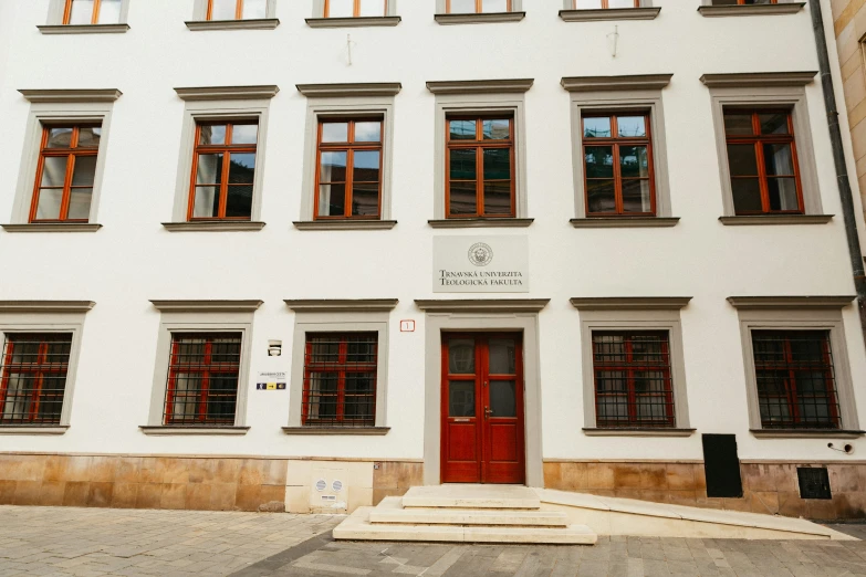 a white building with lots of red doors and windows