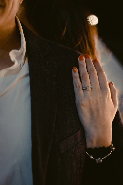 a person with a ring that is standing by her