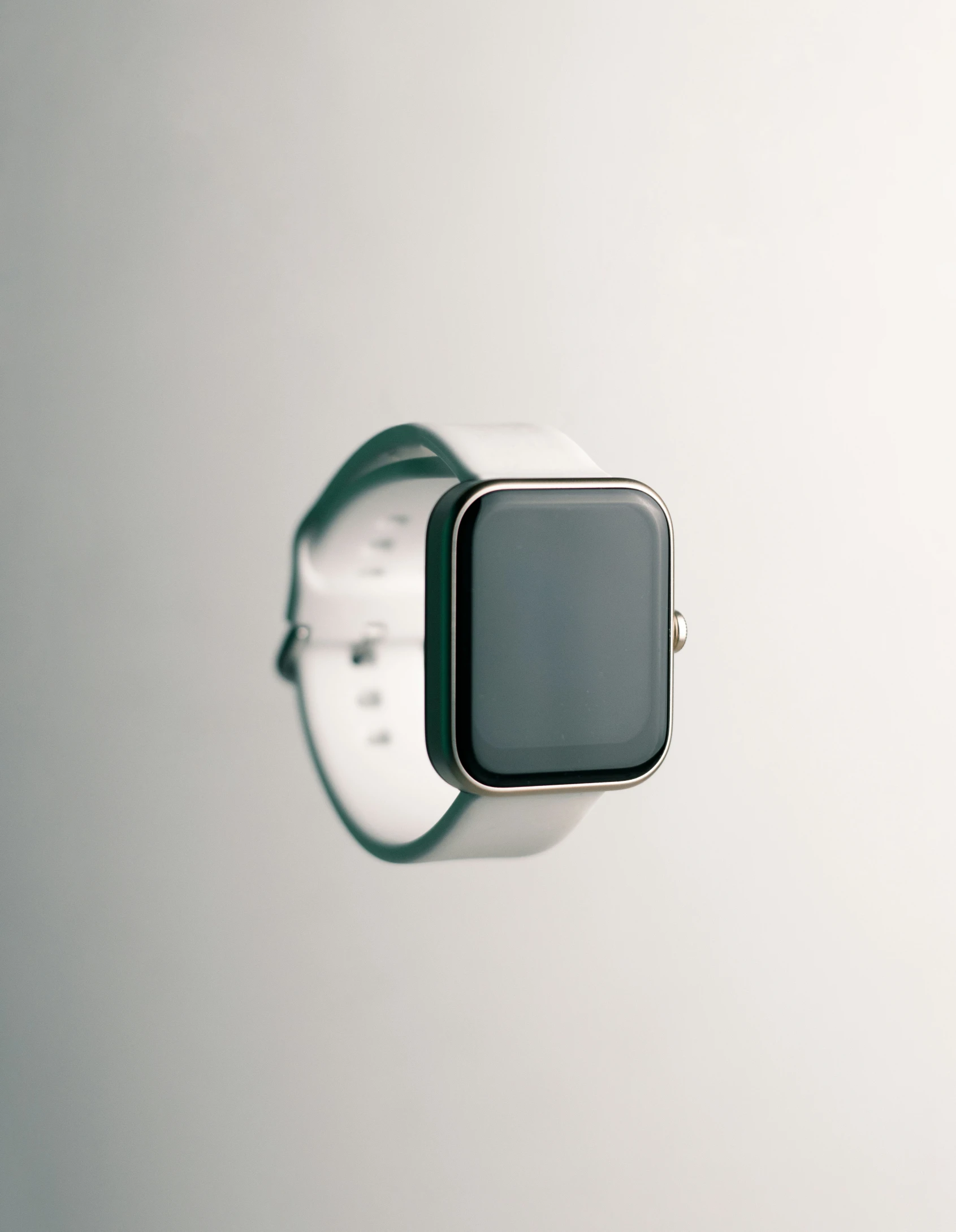 a smart watch sitting on top of a white surface