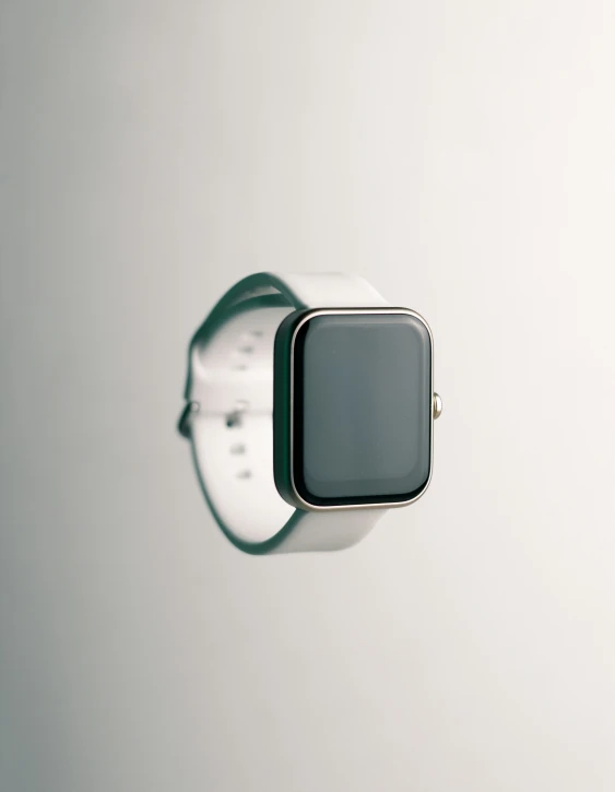 a smart watch sitting on top of a white surface