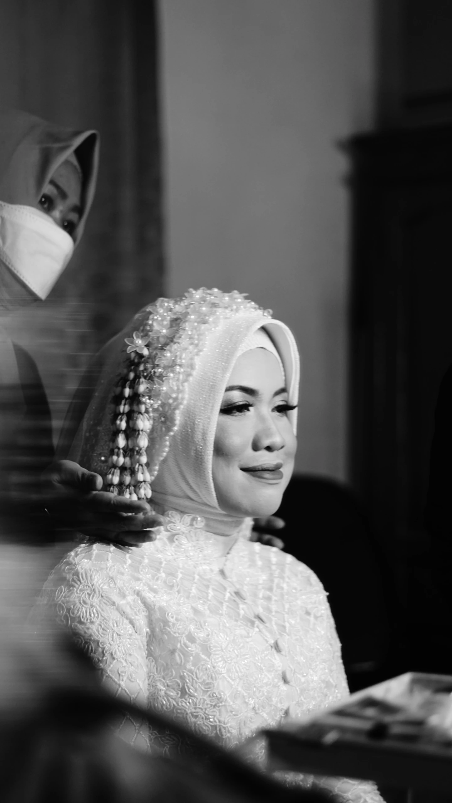 a vintage po of a woman in a dress with beads on her head