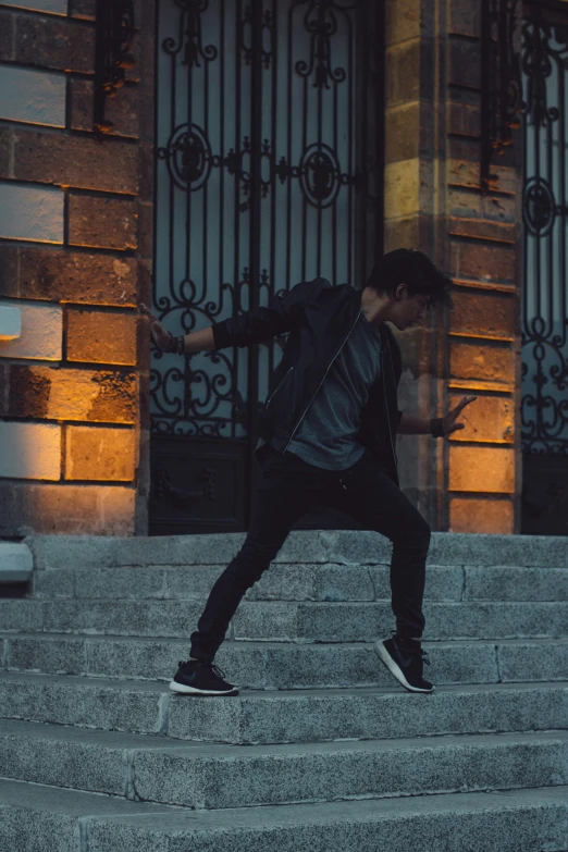 a young man is performing a jump on the steps