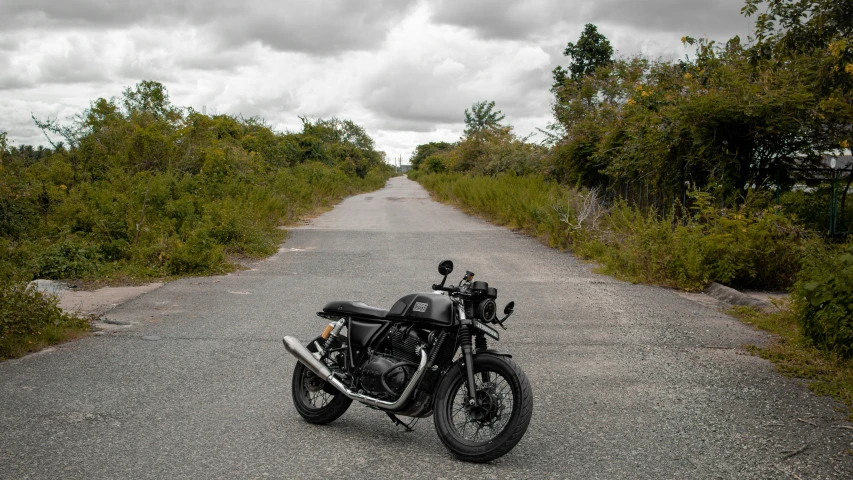 a motor bike that is parked on a paved road