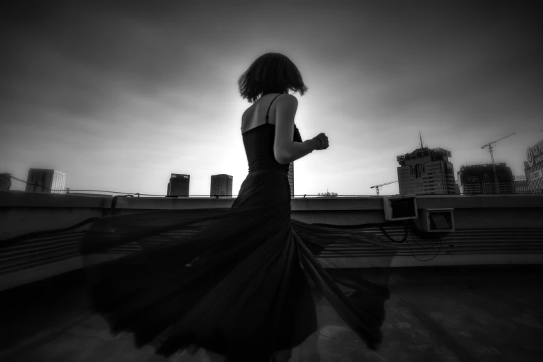 a person running on a rooftop in a dress