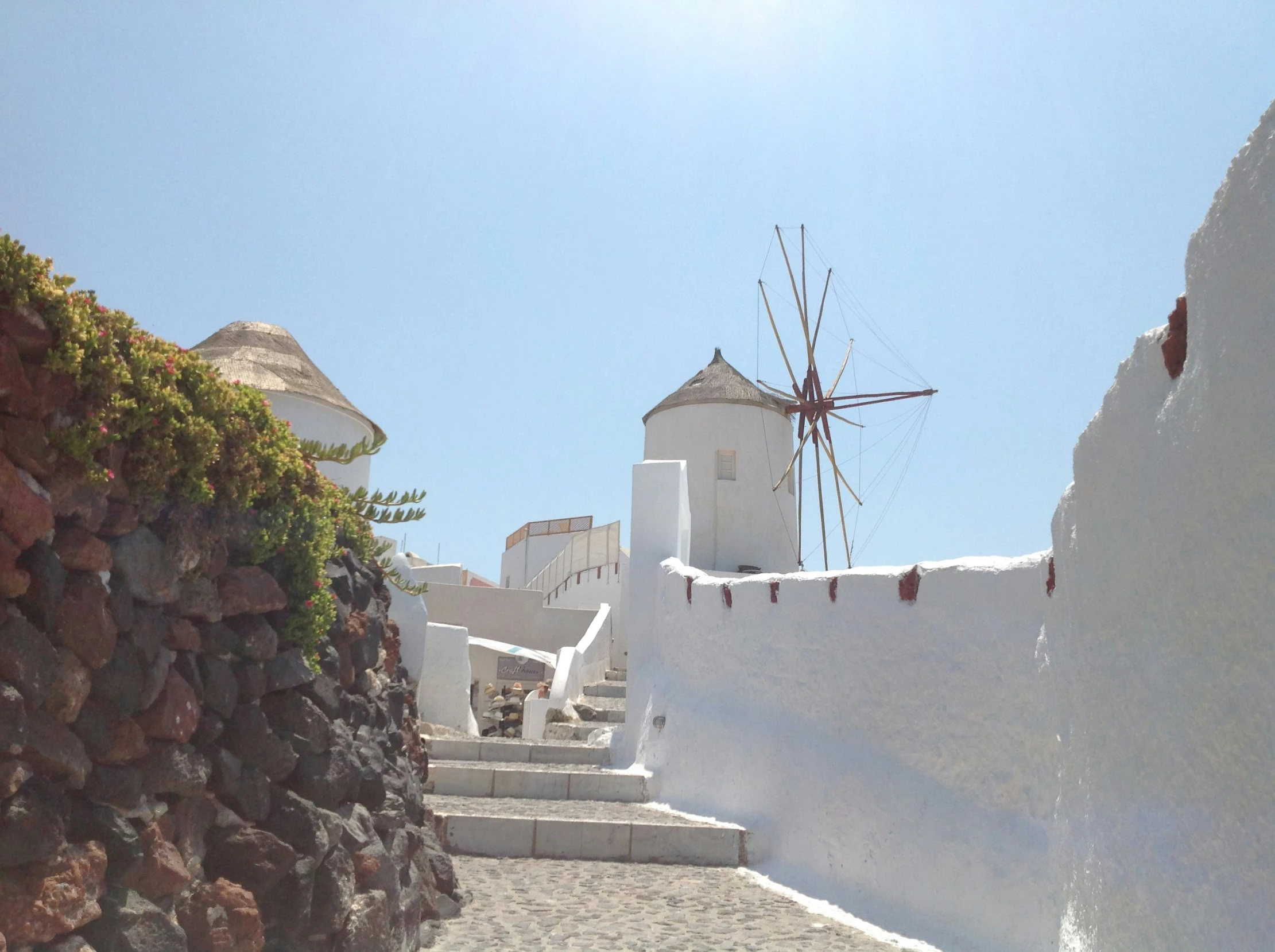 the cobble stone walkway leads to white buildings