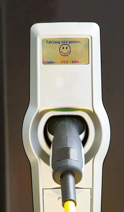 a parking meter has a smiley face on it