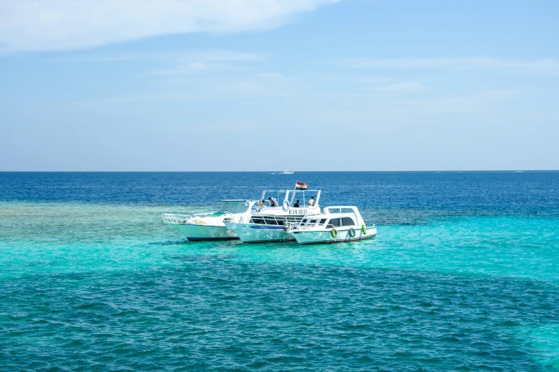 two boats floating near each other on a body of water