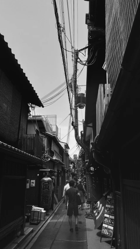 two people walk down a long dark alleyway