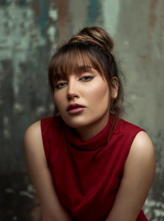 a woman is posing in a red dress