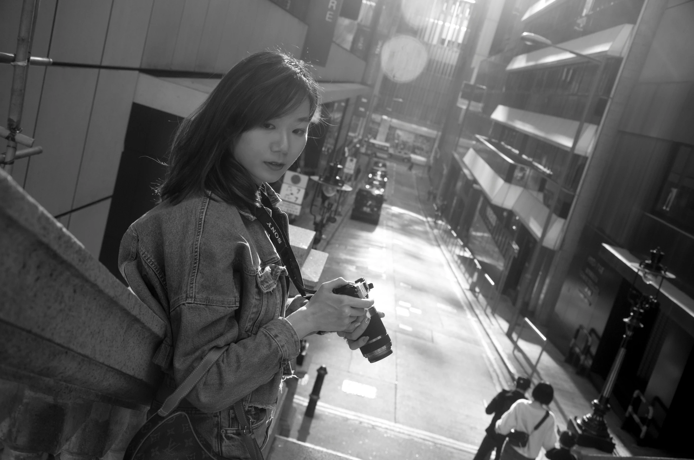 a girl in black and white is on the stairway