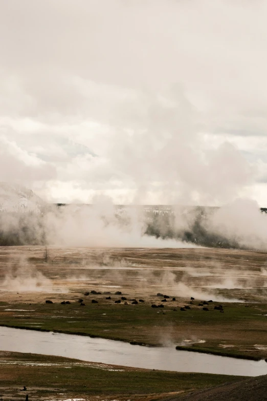 an airplane on a cloudy day flying over a dry landscape