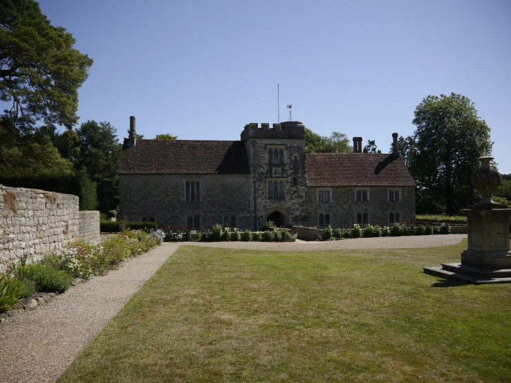 large, large building with multiple windows and lots of plants in the yard