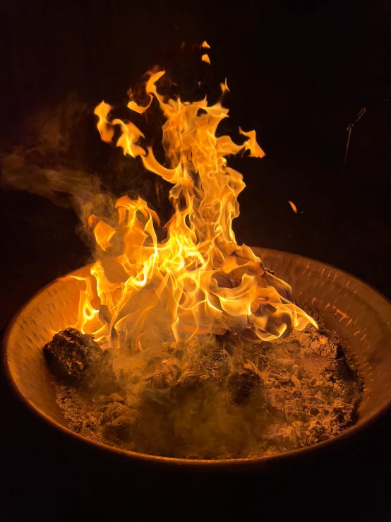 a plate full of fire on a black table