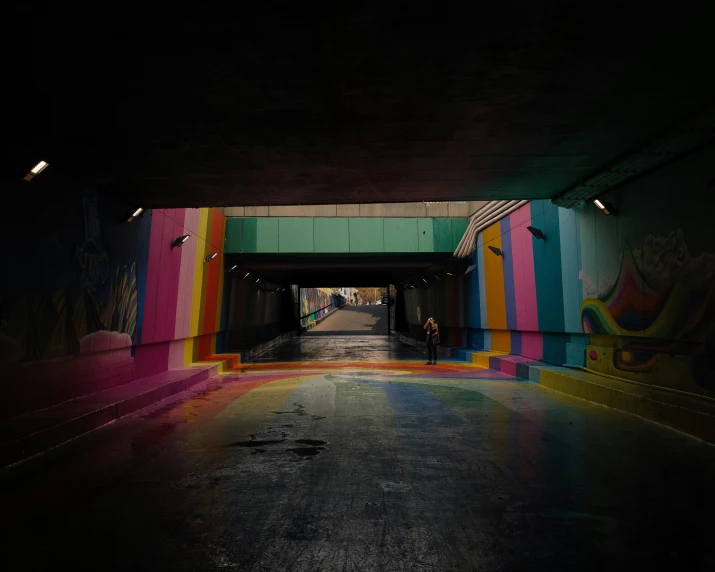 the empty subway tunnel has a colorful strip on it