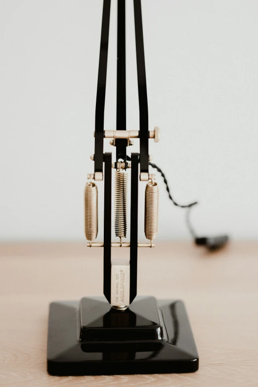 an old clock with multiple gears on a stand