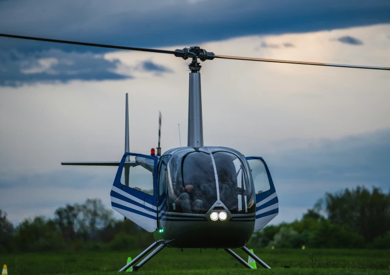 a helicopter is sitting on the grass in a field