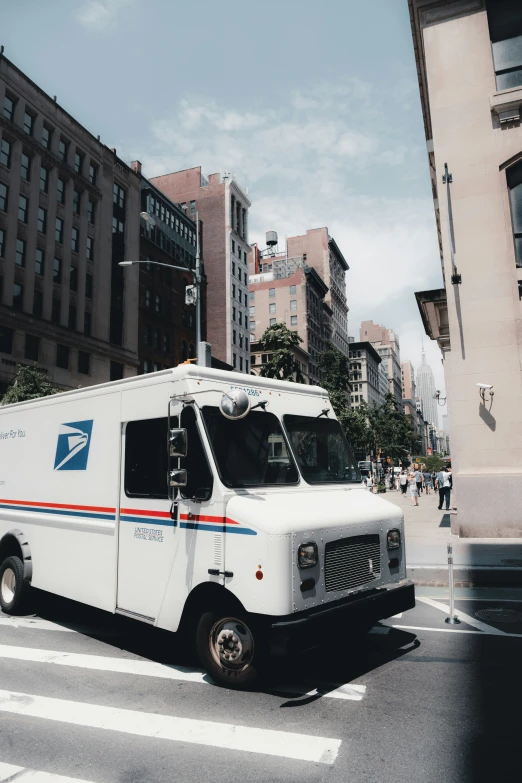 a mail truck driving down the street