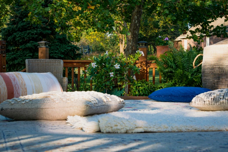 a close up of two pillows on the ground near a bench