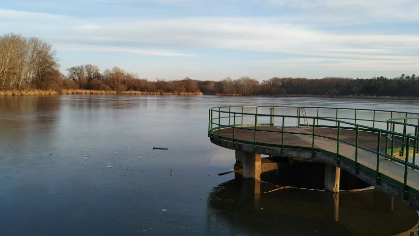 the bridge is over frozen water near a body of water