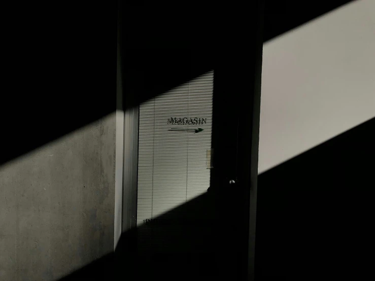 a shadow is cast on the wall with a black door