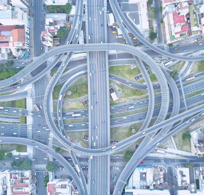 an aerial view of an intersection with lots of vehicles and intersecting roads