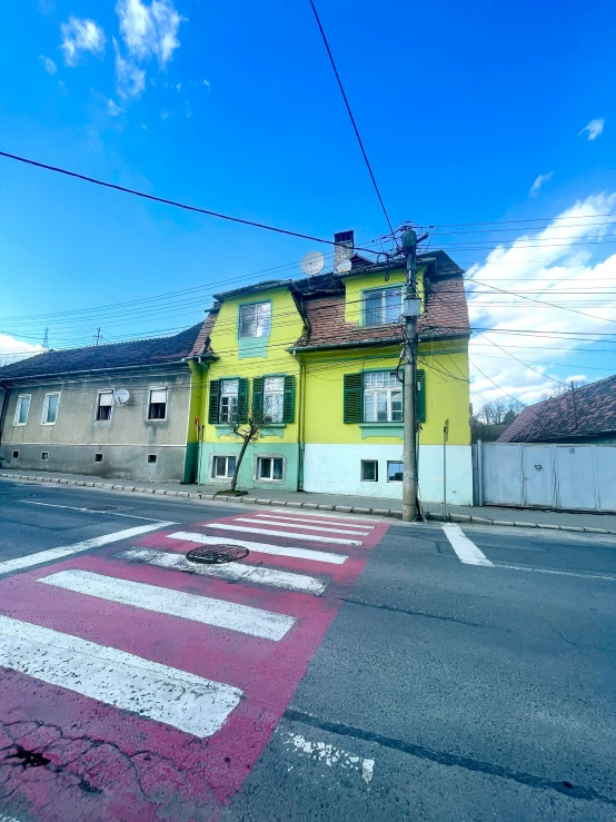 the corner of a street has a parking spot in front of it