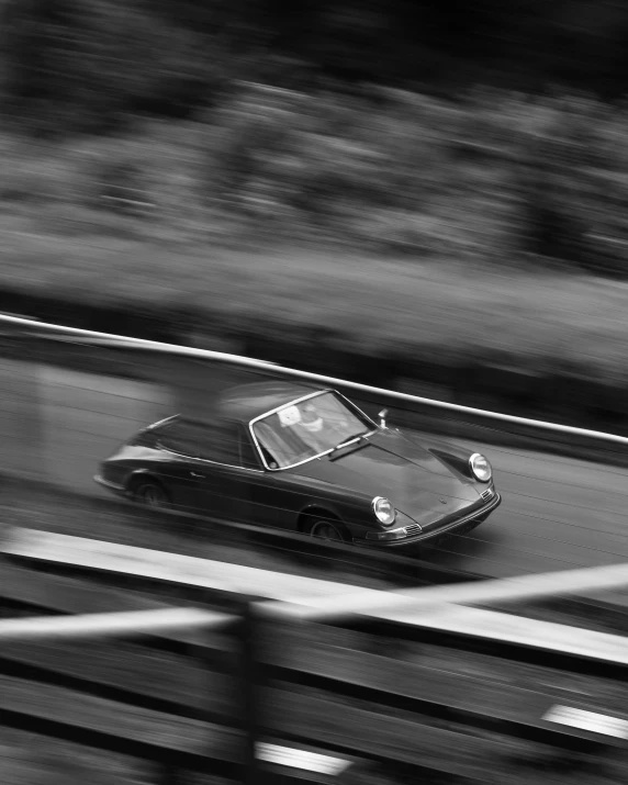 black and white pograph of a car driving on the highway