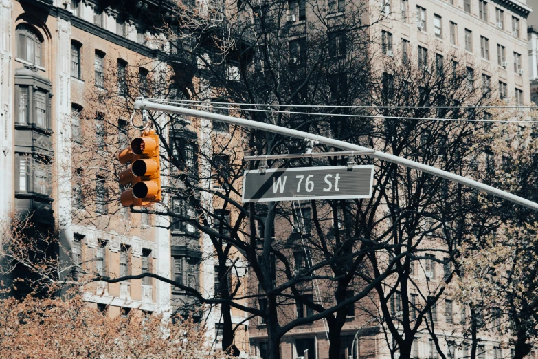 a traffic light hanging on the side of a street