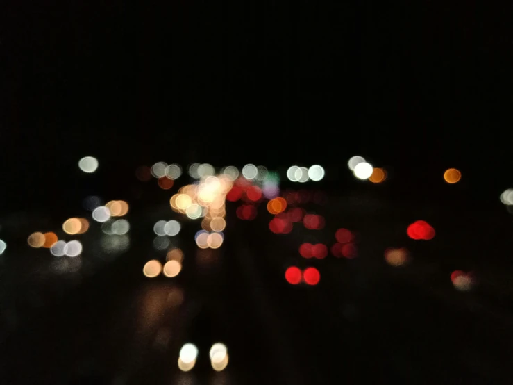 a road with lots of street lights and lots of blurry traffic