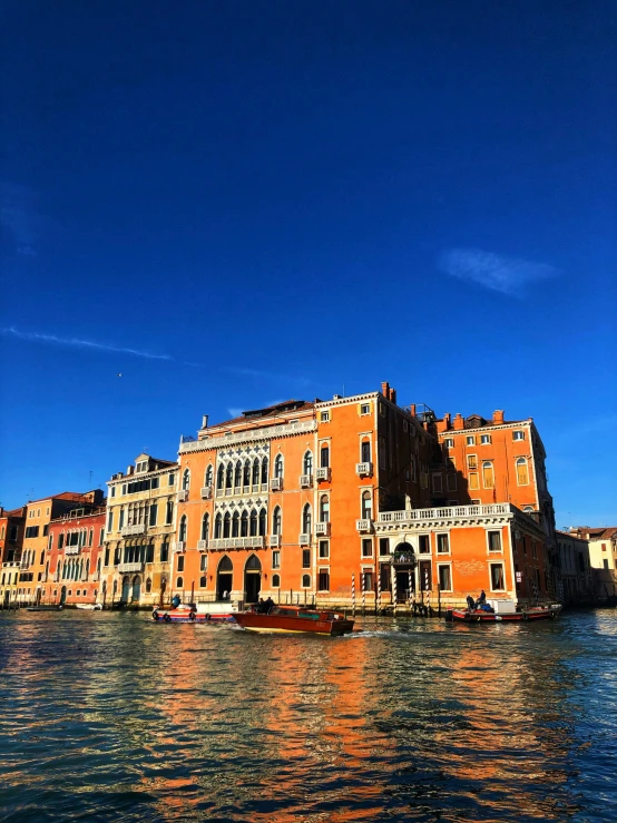 a long building with several stories on the water